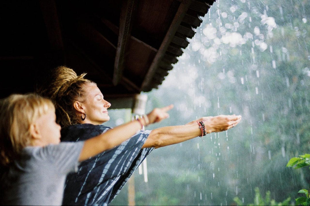 mother and child playing with rain